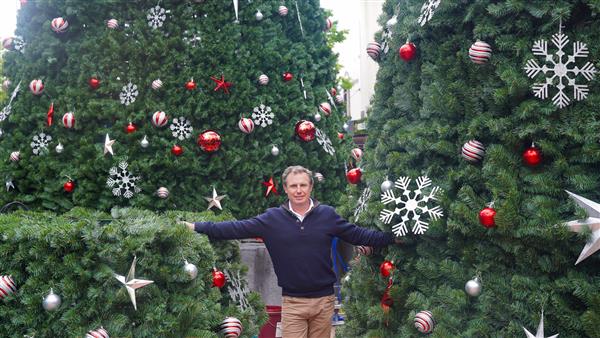 Mayor Sam Coupland next to new Christmas tree mid construction